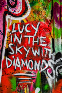 Lennon Wall graffiti in Prague Czech Republic that says Lucy in the Sky with Diamonds